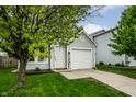 Charming home featuring a well-manicured lawn and an attached one car garage at 1242 Freemont Ln, Greenwood, IN 46143