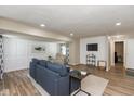 Inviting living room with wood floors, neutral walls, and a comfortable blue sofa at 129 Rosewood Dr, Cicero, IN 46034