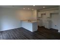 Modern kitchen featuring an island with sink and stylish dark wood flooring at 1400 Bluebonnet Pl, Shelbyville, IN 46176