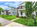 Charming two-story home with balcony, inviting entrance and a lovely landscaped front lawn at 1434 Laurel St, Indianapolis, IN 46203
