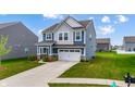 Beautiful two-story home features a two-car garage, blue and gray siding, and a well-manicured lawn at 1464 Buckland Ct, Avon, IN 46123