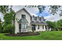 Charming two-story home boasting a beautiful brick facade, bay window, and lush green landscaping at 1536 Copperwood Pl, Carmel, IN 46033