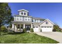 Charming two-story home featuring a welcoming front porch and a three-car garage at 15378 Dorman Ct, Fishers, IN 46040