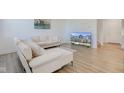 Bright living room with hardwood floors, a white sofa and a large television at 17237 Rancorn Pl, Westfield, IN 46074
