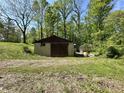 Outbuilding and greenhouse on the property offer additional storage at 1760 Pumpkinvine Hill Rd, Martinsville, IN 46151