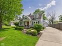 Beautiful light blue home with stone accents, manicured landscaping and long driveway at 2011 Sheffield Ave, Anderson, IN 46011