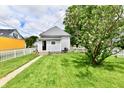 Backyard with a grassy area, a white picket fence, and access to the house at 2335 Main St, Elwood, IN 46036