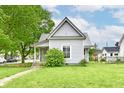 Charming home featuring a metal roof, well-kept lawn, and vibrant green foliage at 2335 Main St, Elwood, IN 46036