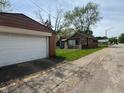 View from the street showing the detached garage and side of the home at 2501 Mars Hill St, Indianapolis, IN 46241