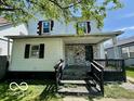 Two-story home showcasing a covered porch and a partially brick facade at 2701 N Gale St, Indianapolis, IN 46218