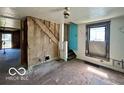 Spacious living room area with hardwood floors, awaiting renovation at 2701 N Gale St, Indianapolis, IN 46218