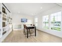 Bright and spacious area with a table and chairs, alongside a curated collection display, creating an inviting atmosphere at 3279 Morab Dr, Zionsville, IN 46077