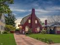 Inviting brick home with warm exterior lighting and a well-kept front yard at 333 N Kenyon St, Indianapolis, IN 46219