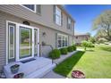 Inviting front entrance with glass accented door, flower pots and manicured landscaping at 3829 Waycross Dr, Columbus, IN 47203