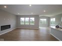 Spacious living room with fireplace and large windows offering natural light and views at 3998 Bozeman Way, Bargersville, IN 46106