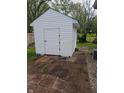 White shed exterior with vinyl siding and double-door access, set on brick pavers at 5043 Harway Ct, Indianapolis, IN 46227
