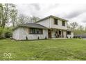 A lovely home with painted brick, a manicured lawn, and a cozy front porch, offering great curb appeal at 5137 Green Hills Dr, Brownsburg, IN 46112