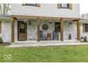 Inviting front porch with rocking chairs, rustic decor, and hanging flower baskets for a charming welcome at 5137 Green Hills Dr, Brownsburg, IN 46112