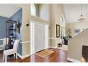 Bright entryway with high ceilings, hardwood floors, and decorative glass block sidelights at the door at 5521 Salem N Dr, Carmel, IN 46033