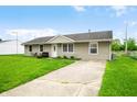 Well-maintained single-story home with a driveway and lush green lawn at 605 Memorial Dr, Edinburgh, IN 46124