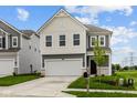 Charming two-story home with a two-car garage, black door, and nicely manicured lawn at 6219 Medina Spirit Dr, Indianapolis, IN 46237