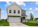 Charming two-story home with a two-car garage, black door, and nicely manicured lawn at 6219 Medina Spirit Dr, Indianapolis, IN 46237
