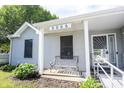 Close up of the front porch and door to the house with a bench at 8066 Cardinal Cove E Dr, Indianapolis, IN 46256