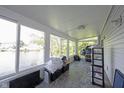 Bright sun room with large windows overlooking a scenic pond at 8066 Cardinal Cove E Dr, Indianapolis, IN 46256