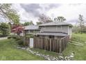 Scenic backyard with a privacy fence, mature trees, and lovely landscaping elements at 8903 Maple Hill Dr, Indianapolis, IN 46239
