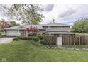 An inviting exterior view with lush landscaping and a rustic fence, enhancing the property's curb appeal at 8903 Maple Hill Dr, Indianapolis, IN 46239