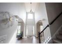 Stunning foyer with soaring ceilings, decorative lighting, and elegant staircase create an inviting entrance at 8970 Buttercup Ct, Noblesville, IN 46060