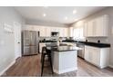 Modern kitchen with white cabinetry, granite countertops, stainless steel appliances, and a center island at 8970 Buttercup Ct, Noblesville, IN 46060