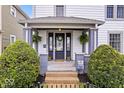 Inviting front porch with decorative plants, wreath, and flowers create a warm welcome at 925 S State Ave, Indianapolis, IN 46203