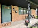 Inviting front porch with green door, decorative ironwork, and space for seating at 100 Lincoln St, Plainfield, IN 46168