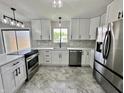Updated kitchen with stainless steel appliances, white cabinets, and stylish countertops at 100 Lincoln St, Plainfield, IN 46168
