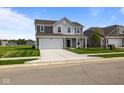 Charming two-story home with attached two car garage and well-manicured lawn at 10126 Redwood Peak Ln, Indianapolis, IN 46259