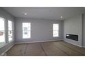 Bright living room featuring recessed lighting, lots of windows, and a modern fireplace at 10544 Maidenhair Dr, Indianapolis, IN 46239