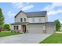 Inviting two-story home with a three-car garage and lush green lawn at 1147 Kelsneland Dr, Avon, IN 46123