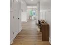Hallway with wood floors leads to a dining area with natural light at 1147 Kelsneland Dr, Avon, IN 46123