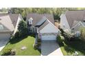 An elevated view of a single Gathering home with a well kept lawn and mature landscaping at 12551 Hawks Landing Dr, Fishers, IN 46037