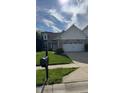 Well-maintained home featuring lush green lawn and a classic mailbox by the sidewalk at 12551 Hawks Landing Dr, Fishers, IN 46037