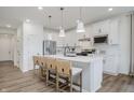 Stylish kitchen features white cabinetry, stainless steel appliances, and a central island with seating at 13324 Roundtop Rd, Noblesville, IN 46060