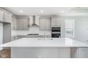 Stylish kitchen with gray cabinets, a central island, stainless steel appliances, and white subway tile backsplash at 13324 Roundtop Rd, Noblesville, IN 46060
