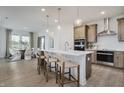 Open-concept kitchen with large island, stainless appliances, and views of dining room at 13355 Seven Springs Ln, Noblesville, IN 46060