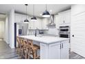 Bright, modern kitchen featuring a large island, stainless steel appliances, and stylish pendant lights at 13355 Seven Springs Ln, Noblesville, IN 46060