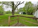 Expansive backyard with a large green storage shed at 1425 E Us Highway 40, Clayton, IN 46118