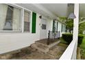 Inviting front entrance with storm door and green shutters at 1425 E Us Highway 40, Clayton, IN 46118