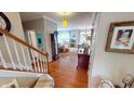 Inviting entryway with hardwood floors, grandfather clock, and staircase at 18247 Kinder Oak Dr, Noblesville, IN 46062