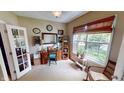 Bright office space with a large window, desk, and neutral carpet at 18247 Kinder Oak Dr, Noblesville, IN 46062