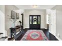 Elegant entryway featuring a dark wood floor, stylish rug, and a modern console table at 1933 S 825 E, Zionsville, IN 46077